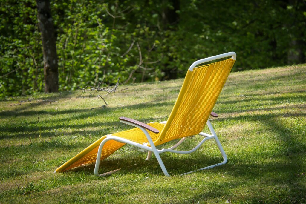Yellow deckchair on a sunny lawn in Bad Wildbad, perfect for summer relaxation.
